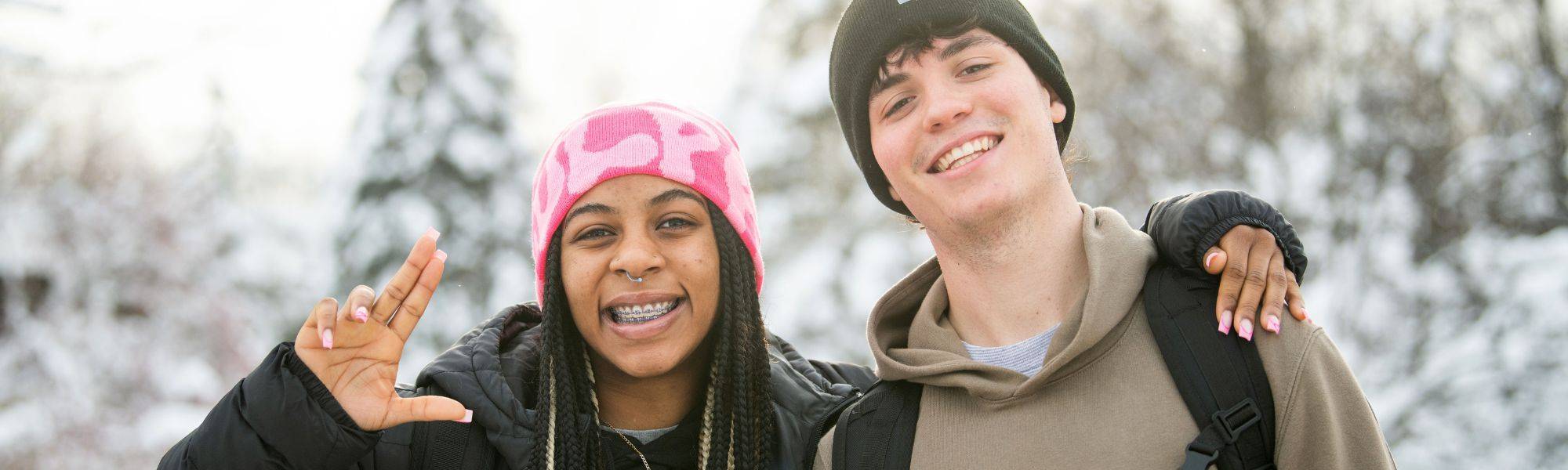 two students walking to class and posing for a picture